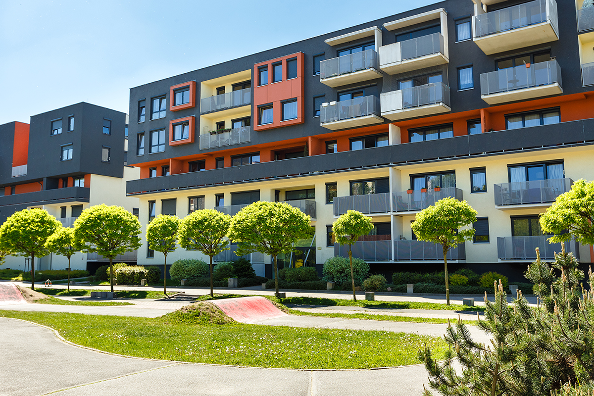 Exterior of a modern apartment buildings on a blue sky background. No people. Real estate business concept.